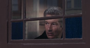 Movie still from “Hachi: A Dog's Tale” (2009), directed by Lasse Hallström – A person looking out of a window; Close Up shot, Over the shoulder angle