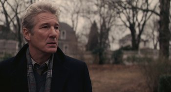 Movie still from “Hachi: A Dog's Tale” (2009), directed by Lasse Hallström – An older man wearing a black coat and a plaid shirt; Close Up shot, Over the shoulder angle