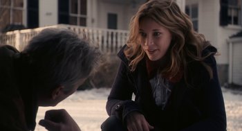 Movie still from “Hachi: A Dog's Tale” (2009), directed by Lasse Hallström – A woman sitting on the ground talking to a man; Medium shot, Over the shoulder angle