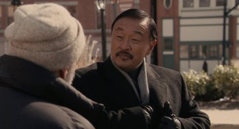Movie still from “Hachi: A Dog's Tale” (2009), directed by Lasse Hallström – An older man wearing a black coat and a white hat; Close Up shot, Over the shoulder angle