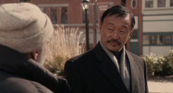 Movie still from “Hachi: A Dog's Tale” (2009), directed by Lasse Hallström – An older man wearing a suit and tie; Close Up shot, Over the shoulder angle