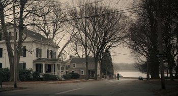 Movie still from “Hachi: A Dog's Tale” (2009), directed by Lasse Hallström – Two people walking down a street near a house; Extreme Wide shot, High angle