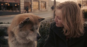 Movie still from “Hachi: A Dog's Tale” (2009), directed by Lasse Hallström – A woman is petting a dog on the head; Close Up shot, High angle