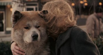 Movie still from “Hachi: A Dog's Tale” (2009), directed by Lasse Hallström – A person with their head on the face of a dog; Close Up shot, Over the shoulder angle