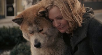 Movie still from “Hachi: A Dog's Tale” (2009), directed by Lasse Hallström – A woman is hugging a brown and white dog; Close Up shot, High angle