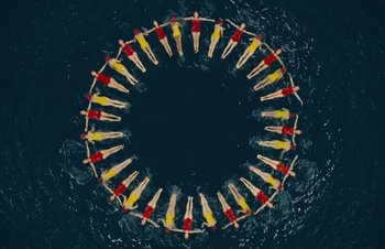 Movie still from “Hail, Caesar!” (2016), directed by Ethan Coen – A group of people swimming in the water; Extreme Wide shot, Overhead angle