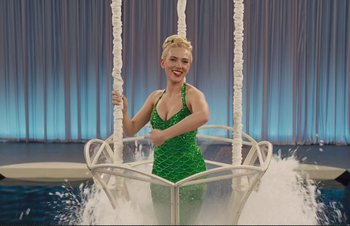 Movie still from “Hail, Caesar!” (2016), directed by Ethan Coen – A woman in a green dress is in the water; Wide shot, High angle
