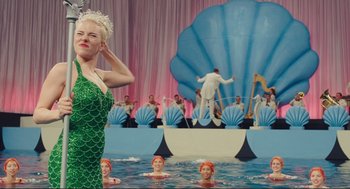 Movie still from “Hail, Caesar!” (2016), directed by Ethan Coen – A group of people in the water with a woman in a mermaid costume; Medium shot, Low angle