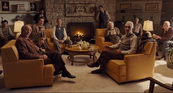 Movie still from “Hail, Caesar!” (2016), directed by Ethan Coen – A group of people sitting around a living room; Wide shot, High angle