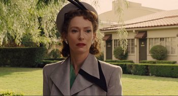 Movie still from “Hail, Caesar!” (2016), directed by Ethan Coen – A woman wearing a hat and a jacket; Medium shot, Over the shoulder angle
