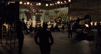 Movie still from “Hail, Caesar!” (2016), directed by Ethan Coen – A group of people sitting in front of a stage; Extreme Wide shot, High angle