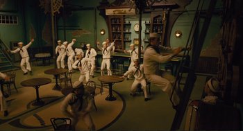 Movie still from “Hail, Caesar!” (2016), directed by Ethan Coen – A group of sailors in a room with tables and chairs; Wide shot, High angle