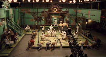 Movie still from “Hail, Caesar!” (2016), directed by Ethan Coen – An overhead view of a stage with people working on it; Extreme Wide shot, High angle