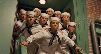 Movie still from “Hail, Caesar!” (2016), directed by Ethan Coen – A group of sailors posing for a picture in front of a mirror; Medium shot, Low angle