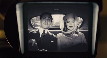 Movie still from “Hail, Caesar!” (2016), directed by Ethan Coen – A man and a woman sitting in the back of a car; Medium shot, Low angle