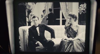 Movie still from “Hail, Caesar!” (2016), directed by Ethan Coen – A man and a woman sitting on a couch in a living room; Medium shot, Low angle