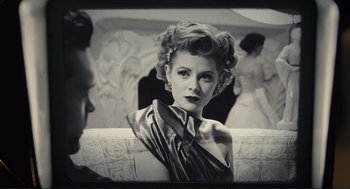 Movie still from “Hail, Caesar!” (2016), directed by Ethan Coen – An old photo of a woman in a satin dress; Close Up shot, Over the shoulder angle