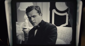 A black and white photo of a man in a tuxedo