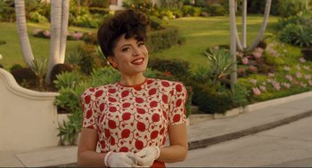 Movie still from “Hail, Caesar!” (2016), directed by Ethan Coen – A woman in a red and white polka dot dress and white gloves; Medium shot, Over the shoulder angle
