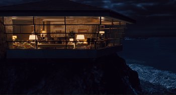 Movie still from “Hail, Caesar!” (2016), directed by Ethan Coen – A room that has a view of the ocean at night time; Extreme Wide shot, Low angle