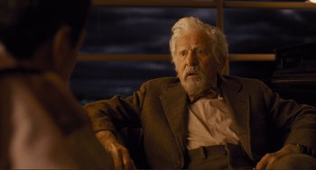 Movie still from “Hail, Caesar!” (2016), directed by Ethan Coen – An older man sitting in front of a window; Close Up shot, Over the shoulder angle