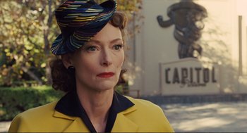 Movie still from “Hail, Caesar!” (2016), directed by Ethan Coen – A person wearing a hat; Close Up shot, Over the shoulder angle