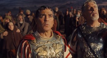 Movie still from “Hail, Caesar!” (2016), directed by Ethan Coen – A man dressed as a roman soldier in front of a group of people; Close Up shot, Over the shoulder angle