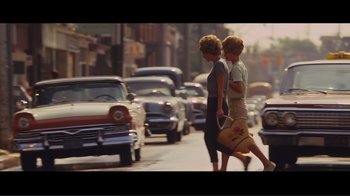 Movie still from “Hairspray” (2007), directed by Adam Shankman – Two women are crossing the street in a busy city; Wide shot, High angle