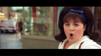 Movie still from “Hairspray” (2007), directed by Adam Shankman – A woman with a surprised look on her face; Close Up shot, Over the shoulder angle