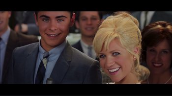 Movie still from “Hairspray” (2007), directed by Adam Shankman – A man and a woman smile for a picture; Close Up shot, Low angle