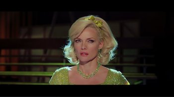 Movie still from “Hairspray” (2007), directed by Adam Shankman – A woman with blonde hair wearing a green dress and a yellow bow; Close Up shot, Over the shoulder angle