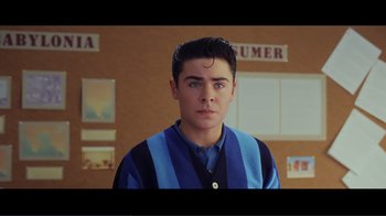 Movie still from “Hairspray” (2007), directed by Adam Shankman – A young man in a blue and black striped sweater; Medium shot, Over the shoulder angle