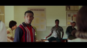 Movie still from “Hairspray” (2007), directed by Adam Shankman – A man standing in front of another man in a room; Medium shot, Over the shoulder angle