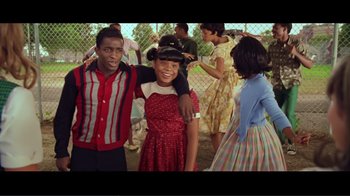 Movie still from “Hairspray” (2007), directed by Adam Shankman – A group of people standing next to each other in a field; Medium shot, Over the shoulder angle