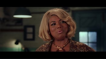 Movie still from “Hairspray” (2007), directed by Adam Shankman – A person wearing a leopard print jacket; Close Up shot, Over the shoulder angle