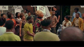 Movie still from “Hairspray” (2007), directed by Adam Shankman – A group of people standing in front of a brick wall; Medium shot, High angle