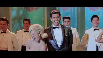 Movie still from “Hairspray” (2007), directed by Adam Shankman – A group of people standing next to each other in a room; Medium shot, Over the shoulder angle