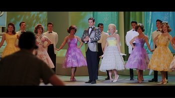 Movie still from “Hairspray” (2007), directed by Adam Shankman – A group of young people dressed up in costumes on a stage; Wide shot, Low angle
