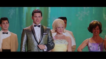 Movie still from “Hairspray” (2007), directed by Adam Shankman – A man and a woman standing next to each other; Medium shot, Low angle