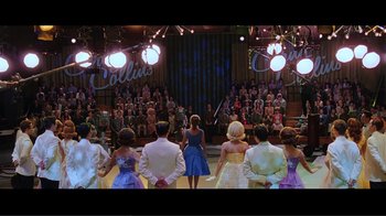 Movie still from “Hairspray” (2007), directed by Adam Shankman – A group of people standing in front of an audience; Wide shot, High angle