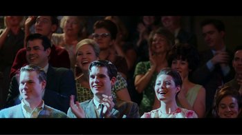 Movie still from “Hairspray” (2007), directed by Adam Shankman – A group of people sitting and standing in front of each other clapping; Medium shot, Over the shoulder angle