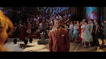 Movie still from “Hairspray” (2007), directed by Adam Shankman – A man standing in front of a crowd of people; Medium shot, Low angle