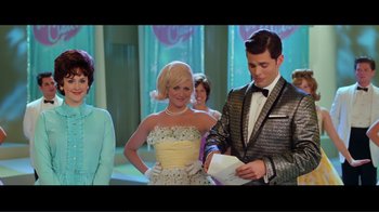 Movie still from “Hairspray” (2007), directed by Adam Shankman – A man and a woman standing next to each other; Medium shot, Over the shoulder angle