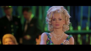 Movie still from “Hairspray” (2007), directed by Adam Shankman – A woman in a colorful dress with a necklace and pearls; Close Up shot, Over the shoulder angle