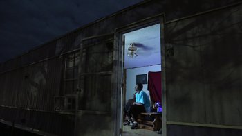 A man sitting on a chair inside of a room