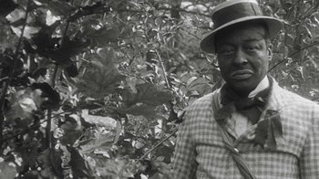 An old black and white photo of a man wearing a hat