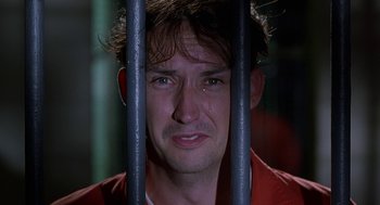 Movie still from “Half Baked” (1998), directed by Tamra Davis – A person behind a fence; Close Up shot, Low angle