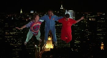 Movie still from “Half Baked” (1998), directed by Tamra Davis – A group of people that are jumping in the air; Wide shot, Overhead angle
