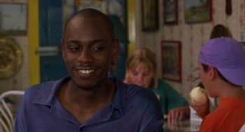 Movie still from “Half Baked” (1998), directed by Tamra Davis – A person sitting at a table; Close Up shot, Over the shoulder angle