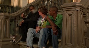 Movie still from “Half Baked” (1998), directed by Tamra Davis – A group of people sitting on steps next to each other; Wide shot, Low angle